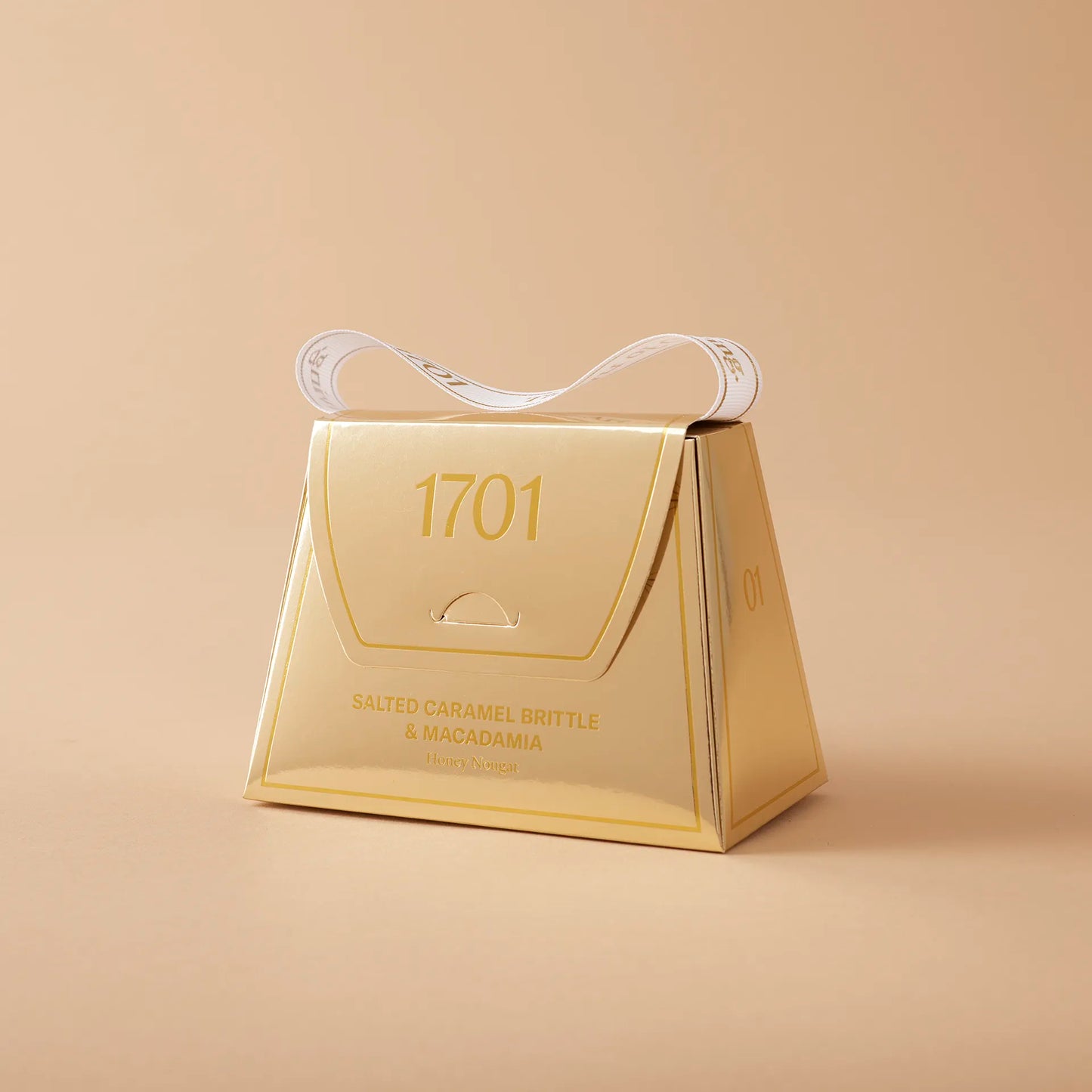 1701 Salted caramel brittle and macadamia honey nougat handbag 140 g ￼